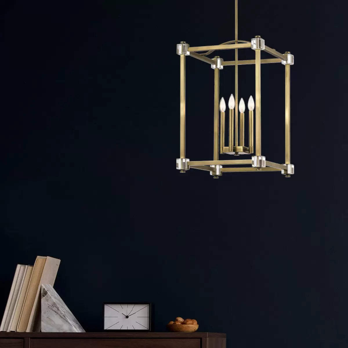 A large Kichler Cayden four-light pendant fixture featuring a gold natural brass steel cage with arched curves and clear optical crystal accents hanging from a high dining room ceiling.