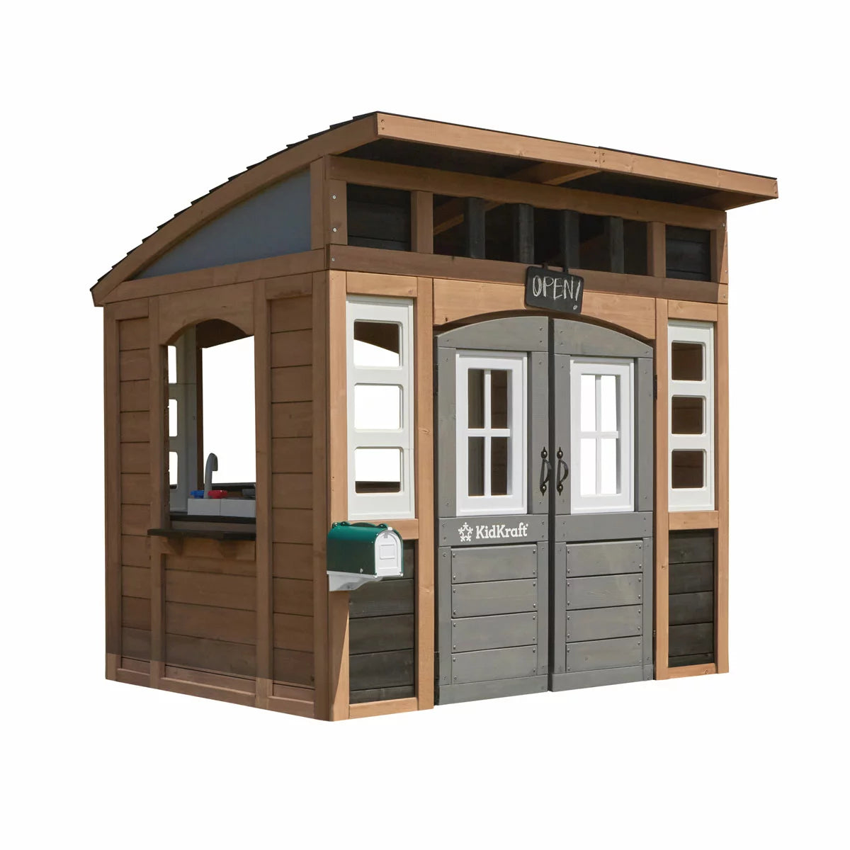 KidKraft Sunny Bluff brown wooden outdoor playhouse with curved double doors, picnic table, kitchen area, chalkboard shutters, and garden play space for children.