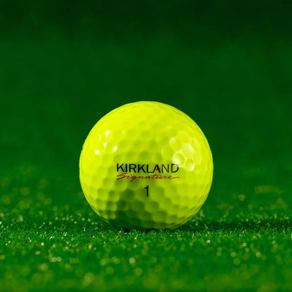 A 24-pack of neon yellow Kirkland Signature three-piece golf balls in their packaging, showcasing the durable urethane cover and 338-dimple pattern designed for optimized aerodynamics