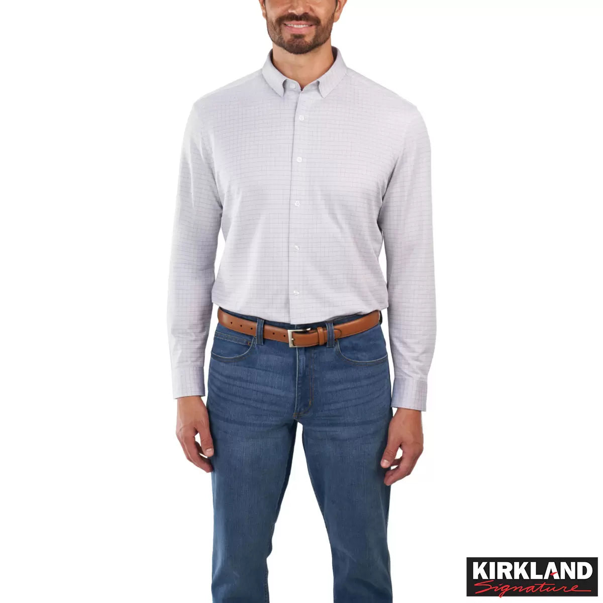 Front view of a man wearing the grey Kirkland Signature Knit Dress Shirt with a spread collar in a bright modern studio setting.