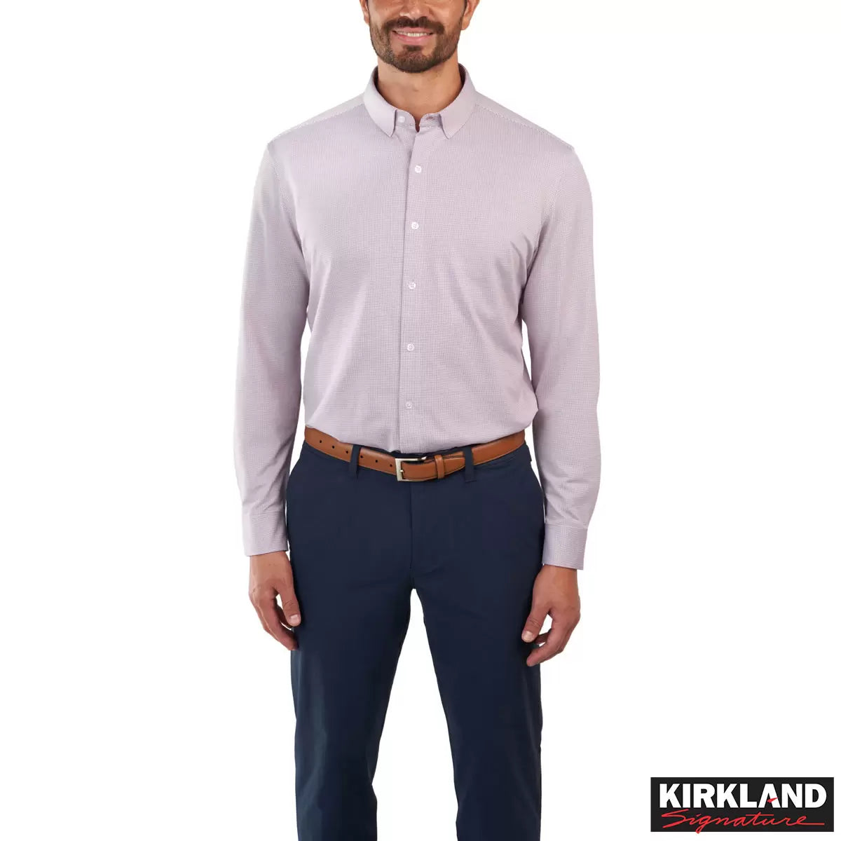 Front view of a man wearing the grey Kirkland Signature Knit Dress Shirt with a spread collar in a bright modern studio setting.