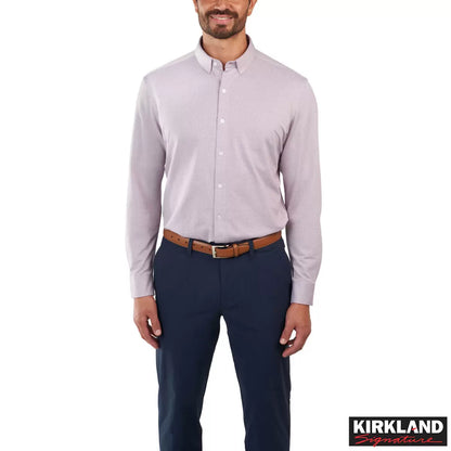 Front view of a man wearing the grey Kirkland Signature Knit Dress Shirt with a spread collar in a bright modern studio setting.