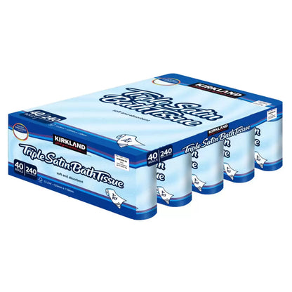 A bulk stack of Kirkland Signature Triple Satin 3-Ply Toilet Tissue packs showing the white, quilted paper rolls in clean, clear packaging on a bathroom shelf environment.