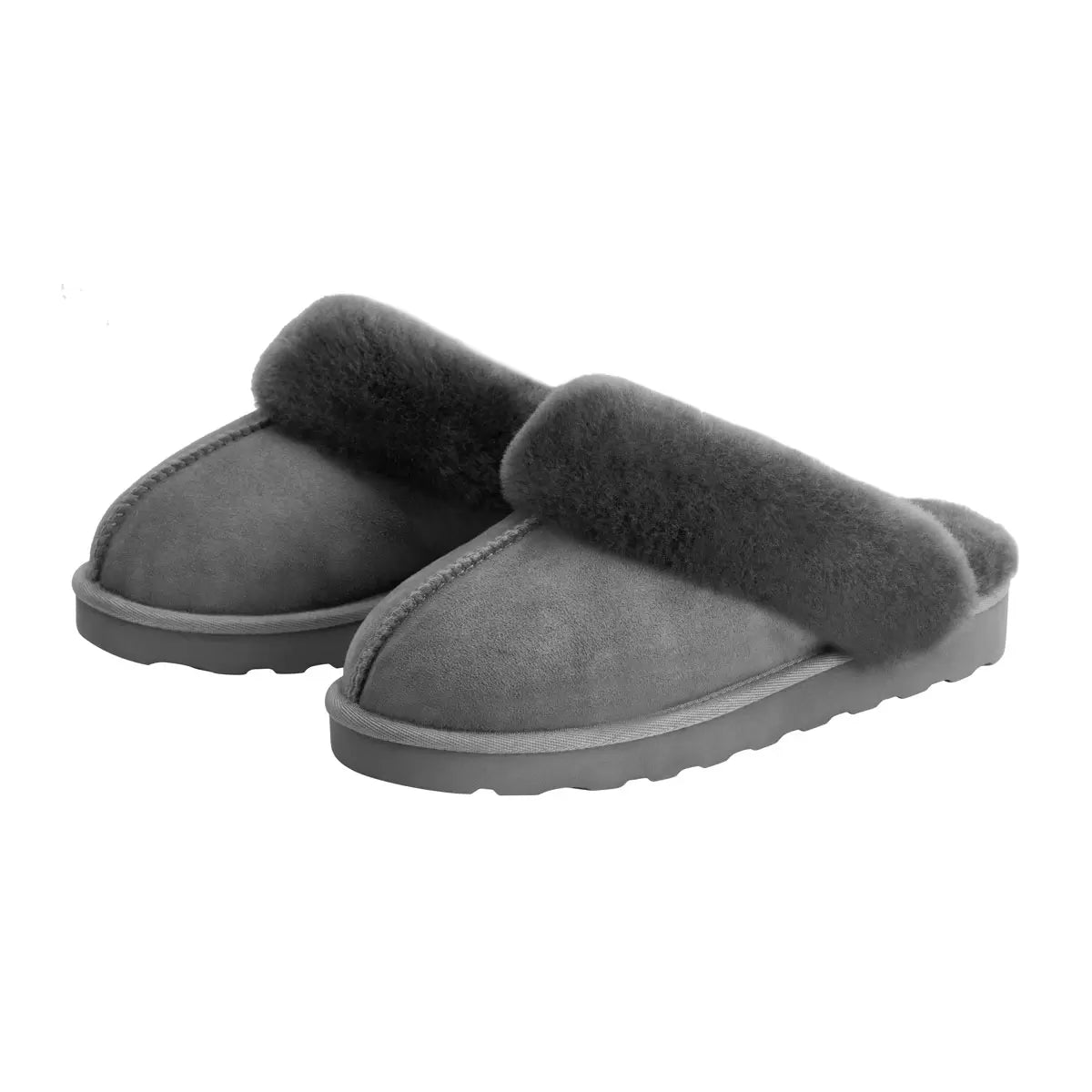 Pair of tan chestnut Kirkland Signature Women's Shearling Slippers featuring plush white wool lining resting on a light wooden floor.