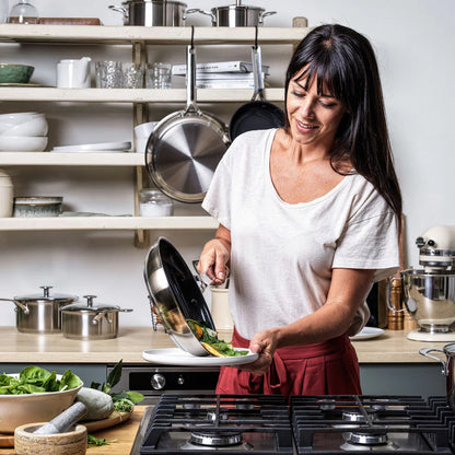 Close-up of the KitchenAid stainless steel pan featuring the ceramic non-stick surface and induction base.