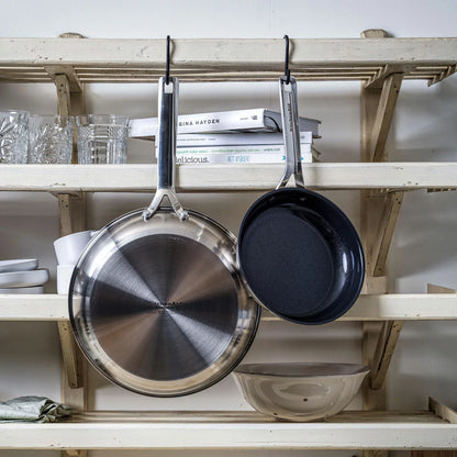 Close-up of the KitchenAid stainless steel pan featuring the ceramic non-stick surface and induction base.