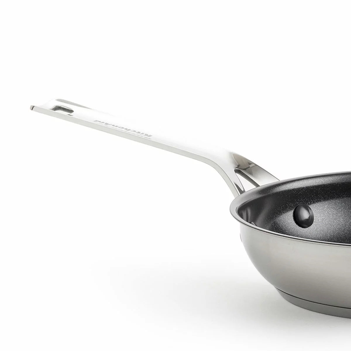 Close-up of the KitchenAid stainless steel pan featuring the ceramic non-stick surface and induction base.