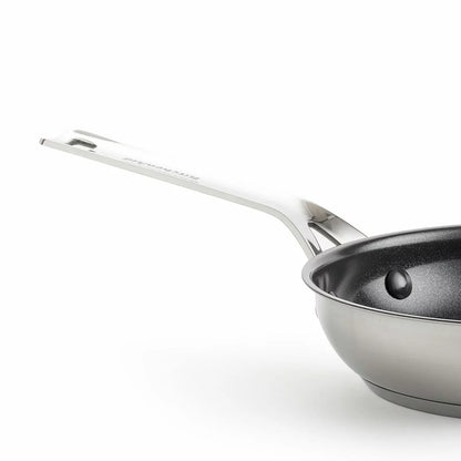 Close-up of the KitchenAid stainless steel pan featuring the ceramic non-stick surface and induction base.
