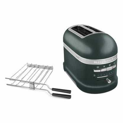 Front angle view of the die-cast KitchenAid Artisan 2-slot toaster on a modern wooden kitchen countertop alongside a toasted sandwich on the included stainless steel rack.