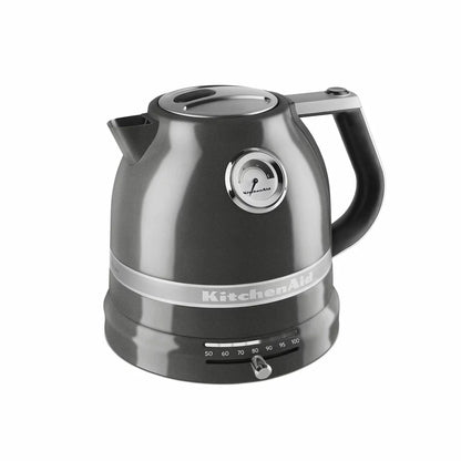 KitchenAid 1.5L retro-style variable temperature kettle in cream with analogue gauge on side resting on a modern wooden kitchen countertop.