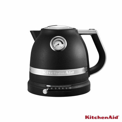 KitchenAid 1.5L retro-style variable temperature kettle in cream with analogue gauge on side resting on a modern wooden kitchen countertop.