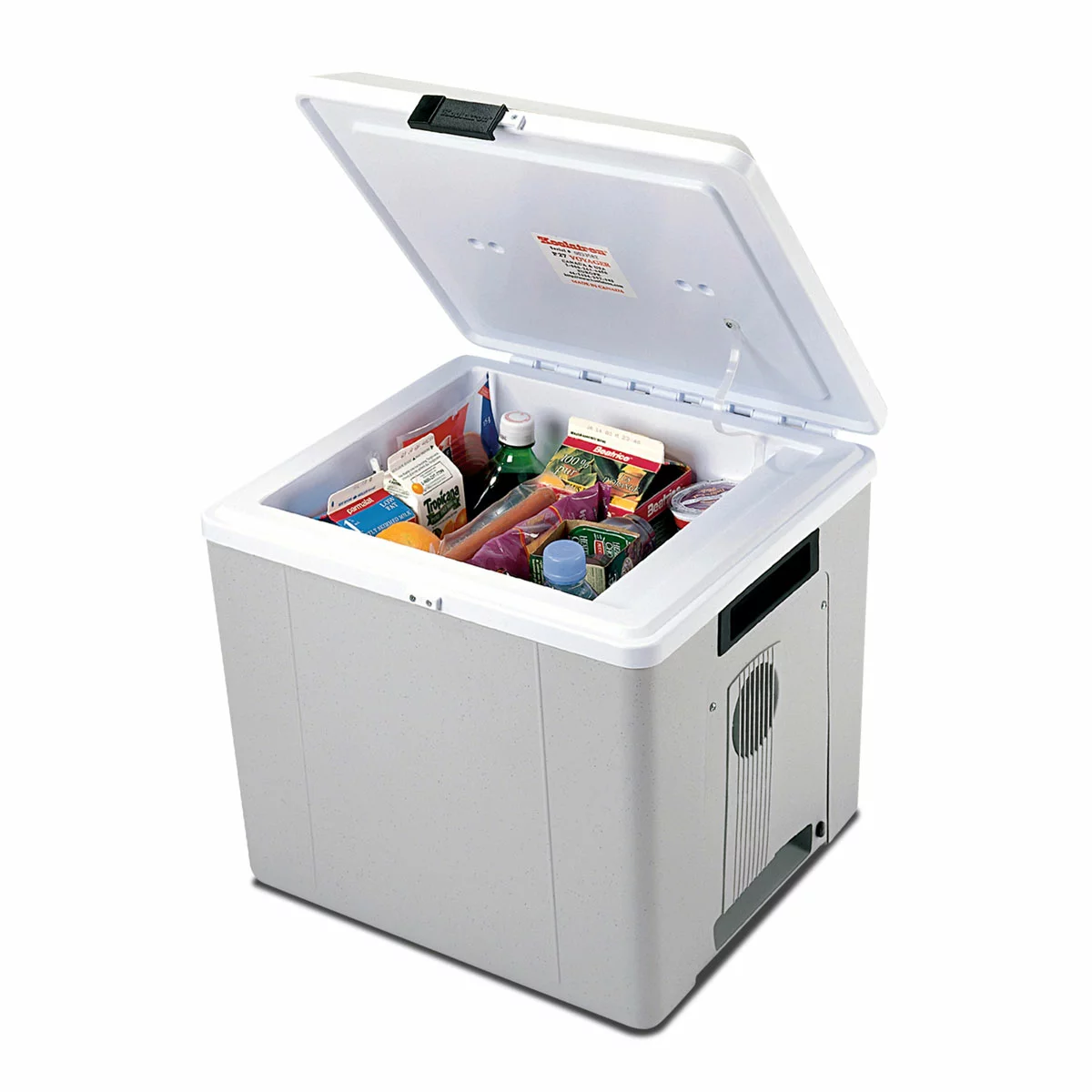 A side-angle shot of the matte grey Koolatron 27L electric cooler box standing upright as a mini-fridge on a gravel campsite, showing its durable injection-molded plastic exterior and sturdy inset handles.
