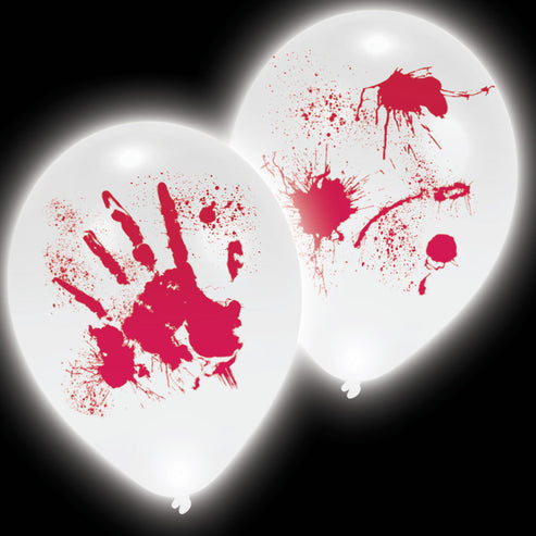 Four inflated white latex balloons with red bloody handprints glowing from internal LEDs against a dark wall backdrop.