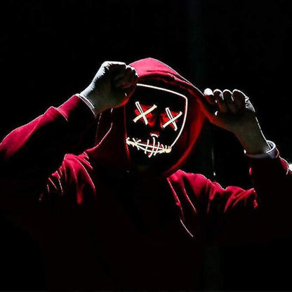 Front view of a black full face Halloween scary cosplay mask illuminated with vibrant glowing orange EL wire against a dark background.
