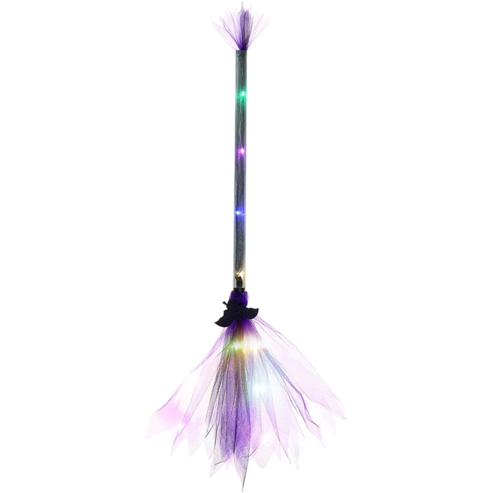 An adjustable light-up LED witch broom wrapped in gauze and ribbon glowing against a dark outdoor background.