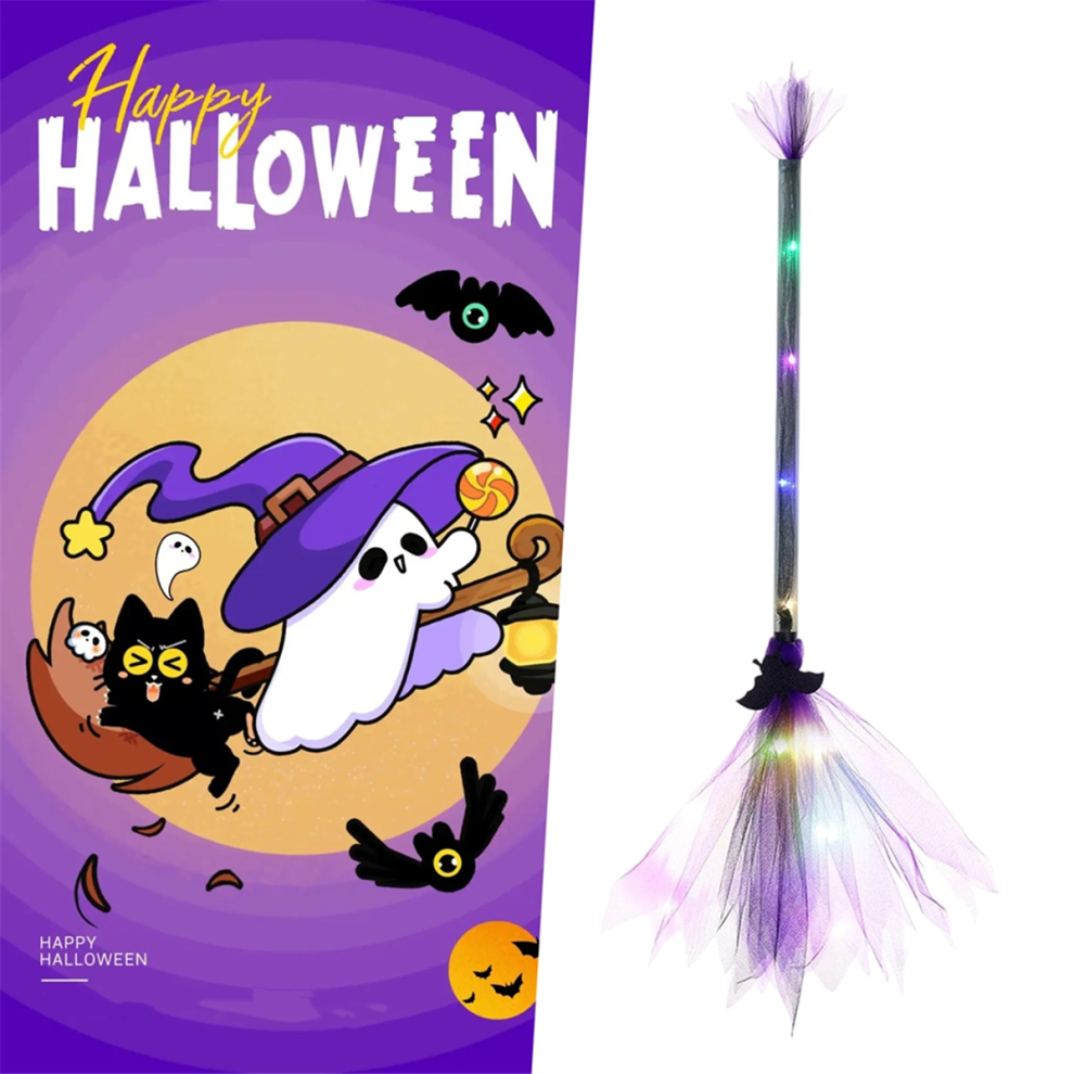 An adjustable light-up LED witch broom wrapped in gauze and ribbon glowing against a dark outdoor background.