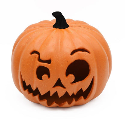A 9.05x7.48in resin LED pumpkin and hooded skull lantern glowing eerily on a dark party display table.