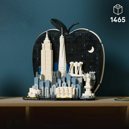 Front studio shot of the built LEGO Architecture 21066 New York City display showing white skyscrapers framed inside a black apple-shaped backdrop.