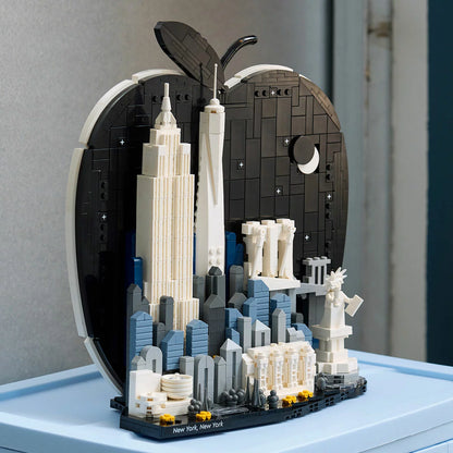 Front studio shot of the built LEGO Architecture 21066 New York City display showing white skyscrapers framed inside a black apple-shaped backdrop.
