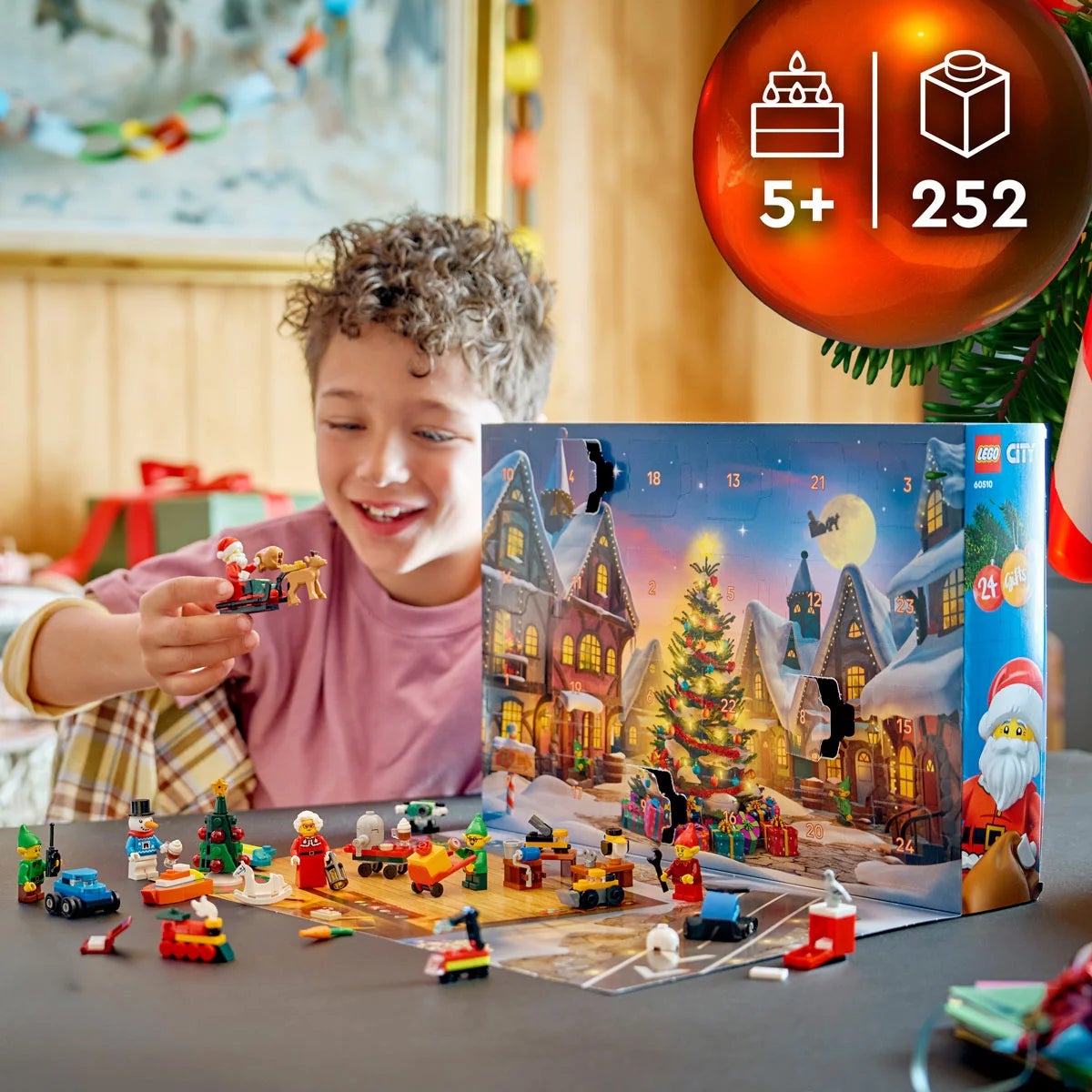 Front view of the unopened LEGO City Advent Calendar 2026 packaging box showing model number 60510 and colorful festive mini-build illustrations set against a bright holiday backdrop.