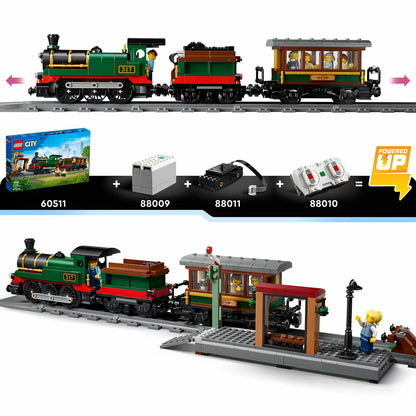 Side profile view of the black LEGO City Vintage Steam Train with red wheels pulling a coal tender and passenger car along a section of track next to a station platform.