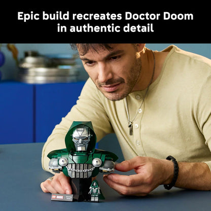 Front angle view of the completed metallic gray and green LEGO Doctor Doom Bust model 76345 on a dark wooden surface.