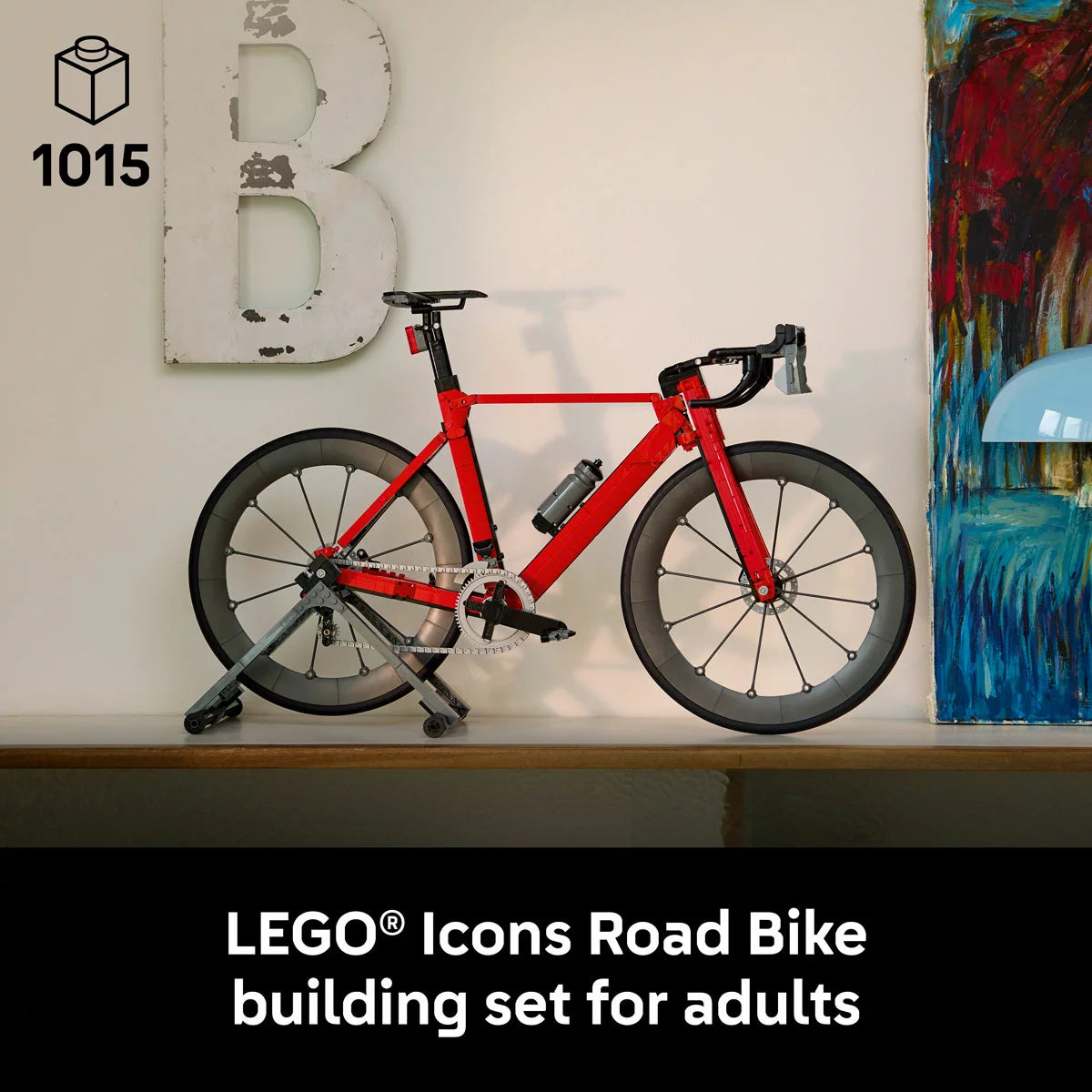 Three-quarter visual of the built LEGO Icons 11380 road racing bicycle model secured on its black paddock stand, showing the silver drive chain and rubber tires.