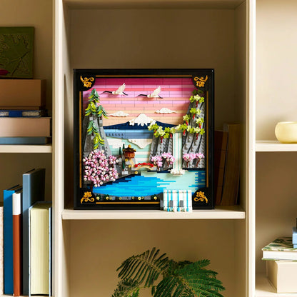 Front angle view of the LEGO 31218 Japanese Cherry Blossom Landscape set in a black frame showing Mount Fuji, pink cherry blossoms, and an adjusting 3D waterfall.