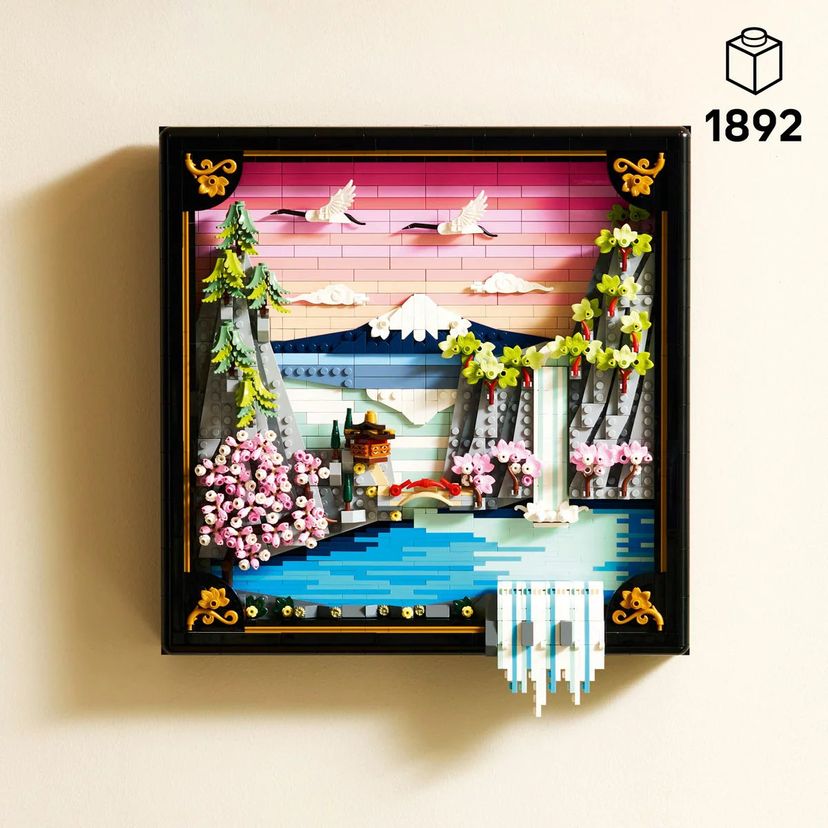 Front angle view of the LEGO 31218 Japanese Cherry Blossom Landscape set in a black frame showing Mount Fuji, pink cherry blossoms, and an adjusting 3D waterfall.