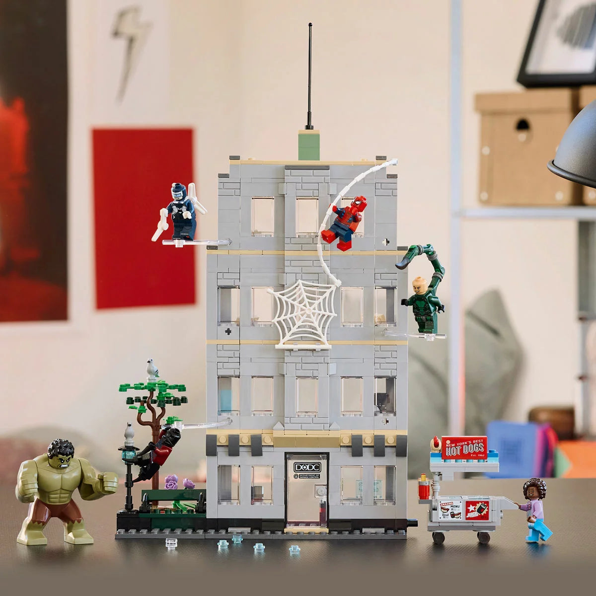 Front angle view of the LEGO Marvel Spider-Man vs. Hulk Epic Clash set showing the exploding office wall structure, Hulk big figure, and Spider-Man suspended on a clear rod.