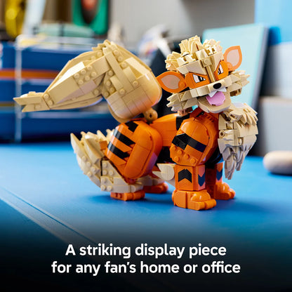 Front three-quarter view of the assembled orange and cream LEGO Pokémon Arcanine figure posed dynamically on a clean dark wood desk.