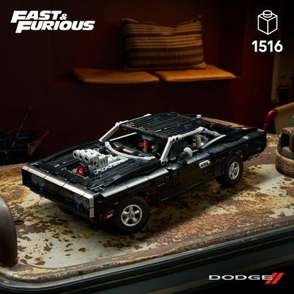 Three-quarter overhead view of the built black LEGO Technic 42231 Dodge Charger R/T muscle car model showing its chrome engine intake and wide rubber racing tires.
