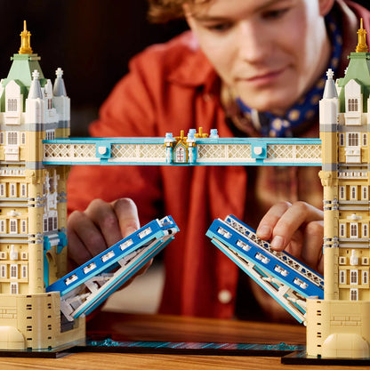 Front angle view of the assembled LEGO Architecture Tower Bridge 21067 set featuring blue suspension cables, raised central bascules, and microscale buses on the base.d