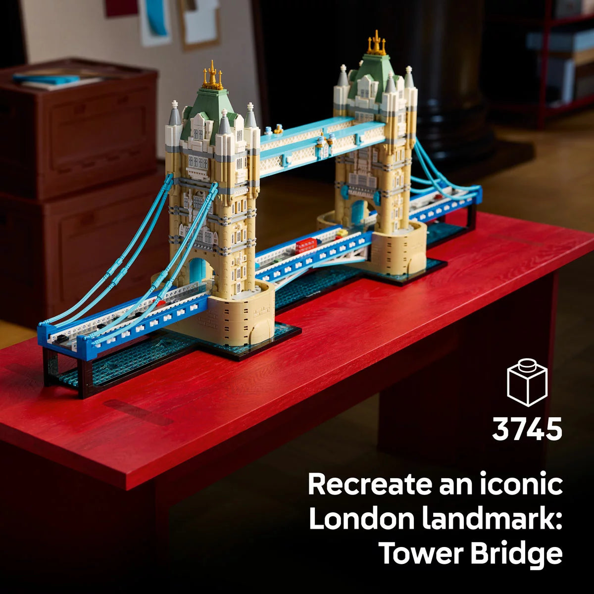 Front angle view of the assembled LEGO Architecture Tower Bridge 21067 set featuring blue suspension cables, raised central bascules, and microscale buses on the base.