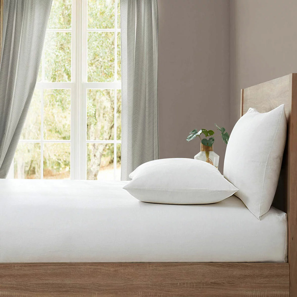 Crisp washed white Lazy Linen double fitted sheet pulled smooth over a deep mattress showcasing its natural flax texture.