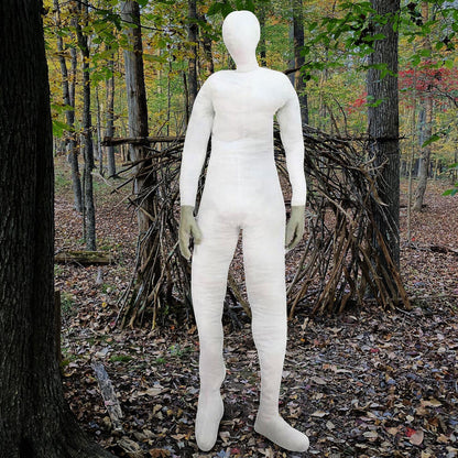 A lifesize 6-foot stuffed bendable mannequin display dummy dressed in a Halloween costume prop setup on a dark stage.