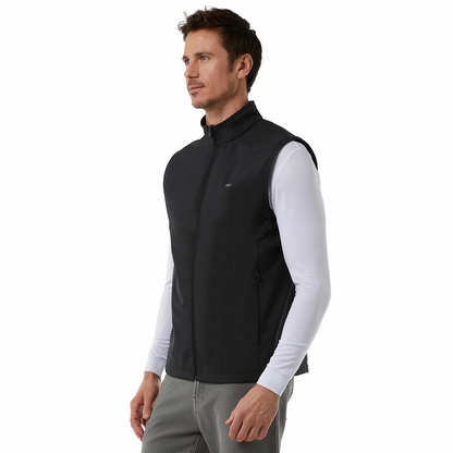 Black 32 Degrees heated vest laid flat displaying the glowing LED power button on the chest and the compact 10,000mAh battery pack resting nearby.