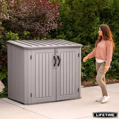 Lifetime 1300 litre horizontal garden storage shed with a realistic wood-look rough cut finish, shown with open doors revealing two standard wheelie bins.