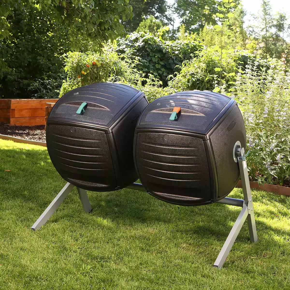 A side-by-side view of the Lifetime 378L dual tumbling composter on a sturdy steel base, situated on a clean garden patio, showing the black panels and red processing indicators.