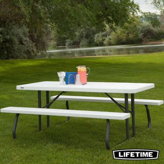 Lifetime 6ft classic white folding picnic table with attached benches on a green lawn.
