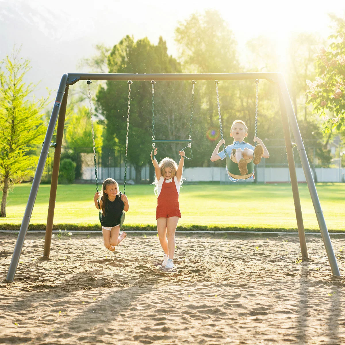 Lifetime 7ft green and tan steel garden swing set featuring two classic swings, a trapeze bar with gym rings, and a durable weather-resistant frame in a family garden-1