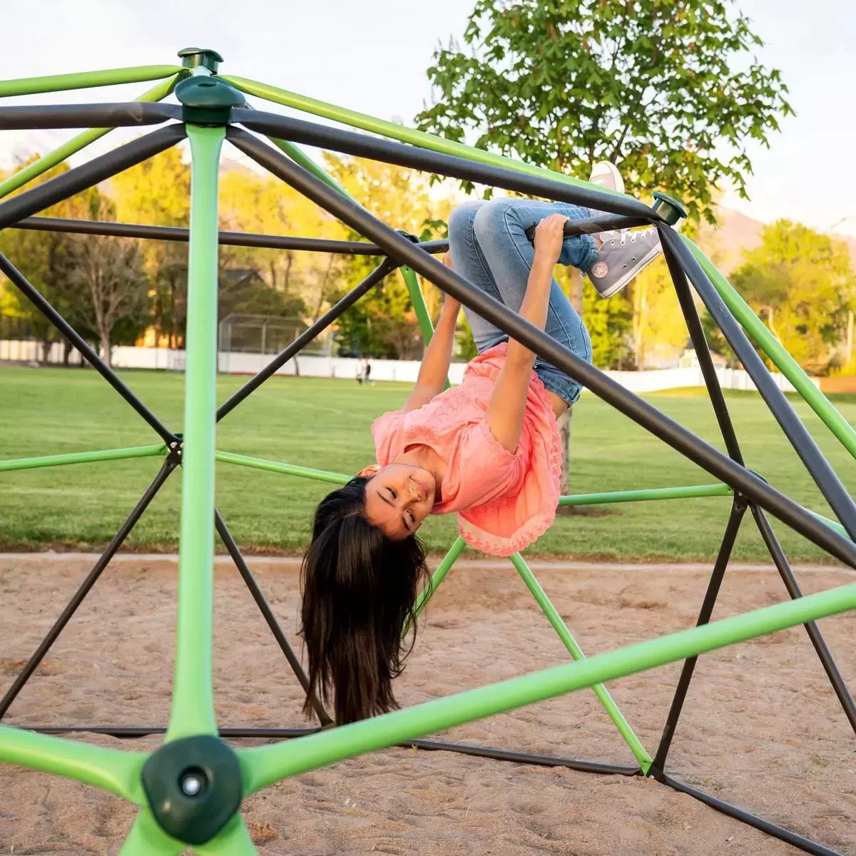 Geometric heavy-duty steel Lifetime climbing dome set up on a green grass garden lawn under sunny skies.
