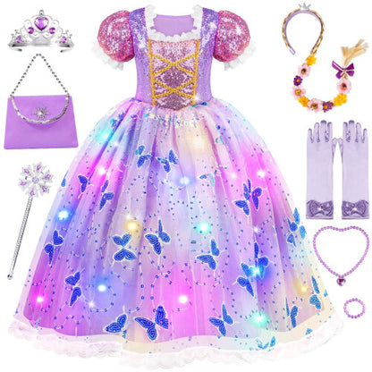 Front view of a young girl wearing a flowing purple sequined light-up princess dress with lace sleeves, holding a silver wand and wearing a matching glowing wig and crown.