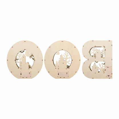 Set of three large illuminated wooden BOO letters featuring detailed laser-cut Halloween scenes emitting a warm LED glow on a dark wooden mantle shelf.
