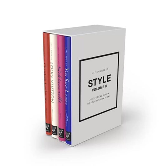 Front view of four pocket-sized hardback fashion books in a beige slipcase featuring titles for Louboutin, Louis Vuitton, Schiaparelli, and Yves Saint Laurent on a neutral surface.