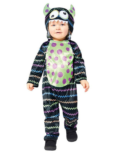 Front view of a child wearing a soft blue and orange Little Monster Costume jumpsuit with an attached character face hood in a cozy living room setting.