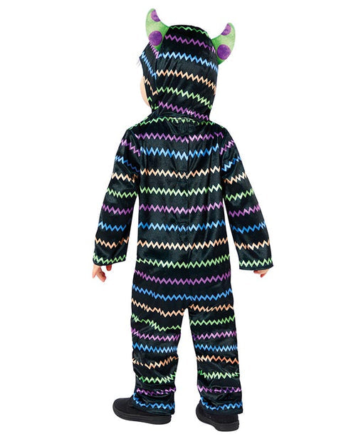 Front view of a child wearing a soft blue and orange Little Monster Costume jumpsuit with an attached character face hood in a cozy living room setting.