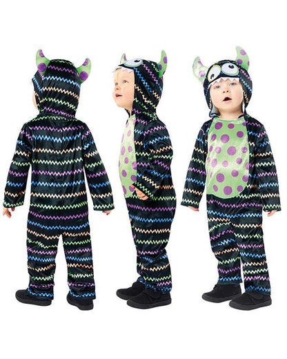 Front view of a child wearing a soft blue and orange Little Monster Costume jumpsuit with an attached character face hood in a cozy living room setting.