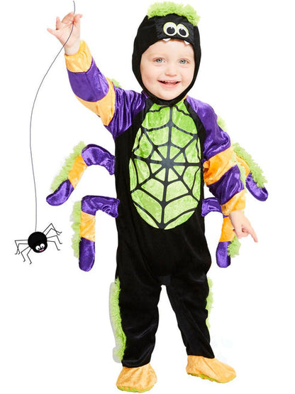 Toddler wearing a bright plush Little Spooky Spider costume with soft attached legs outdoors on a trick-or-treat walkway.