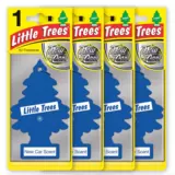 A 24-pack box of colorful Little Trees air fresheners featuring Vanillaroma, Black Ice, and New Car Scent hanging trees displayed against a clean automotive interior background.